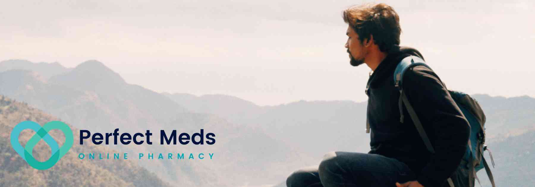 male traveller wearing backpack admiring view of mountains