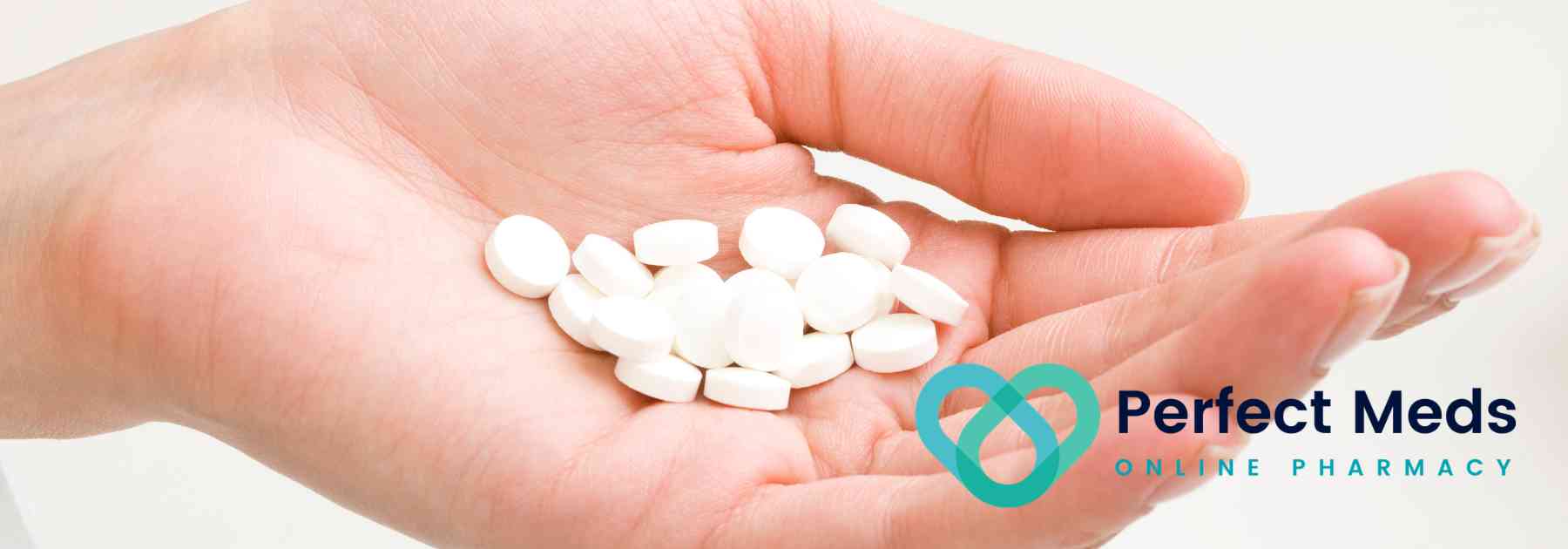 person holding white pills in their hand
