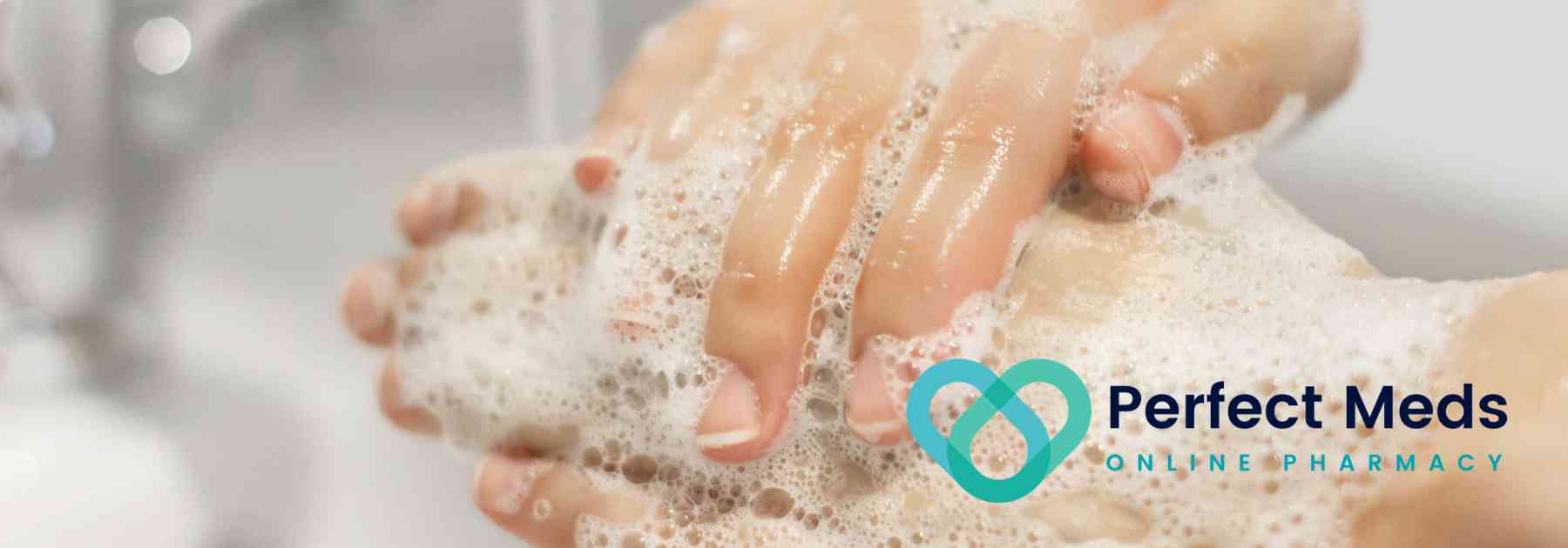 person washing hands with soap and water