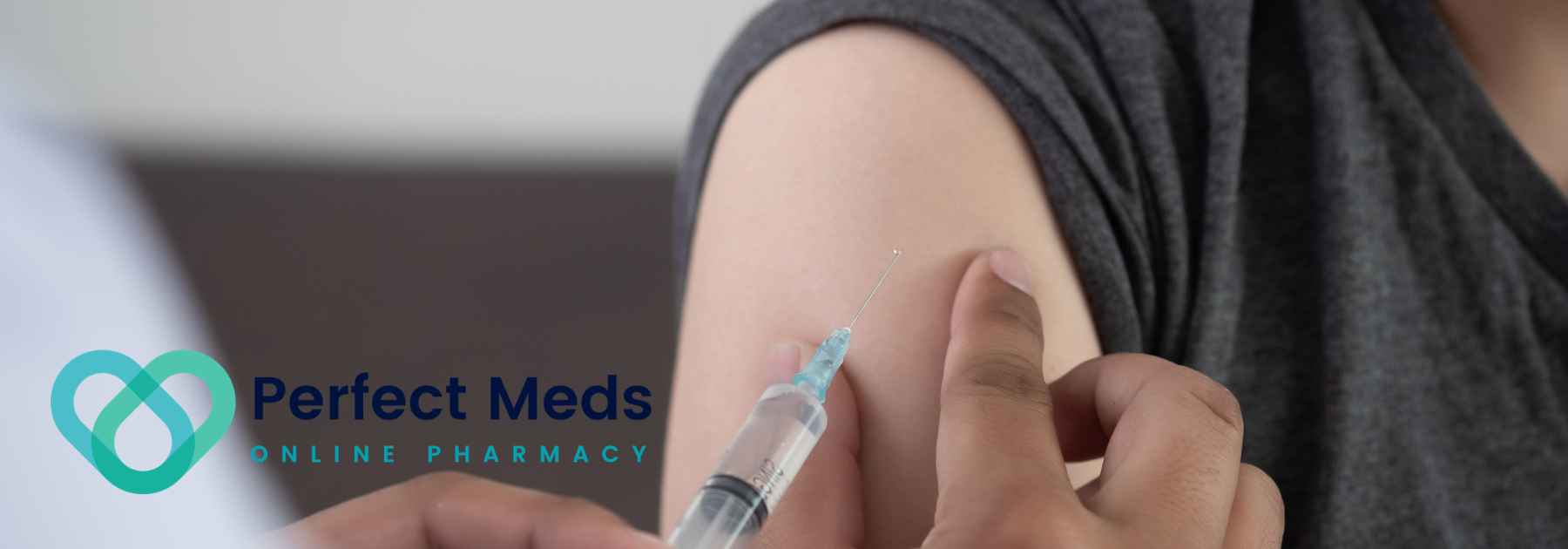 person in grey shirt receiving vaccine