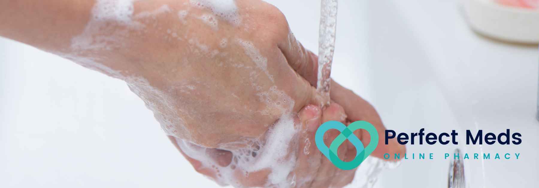 person washing their hands with soap and water