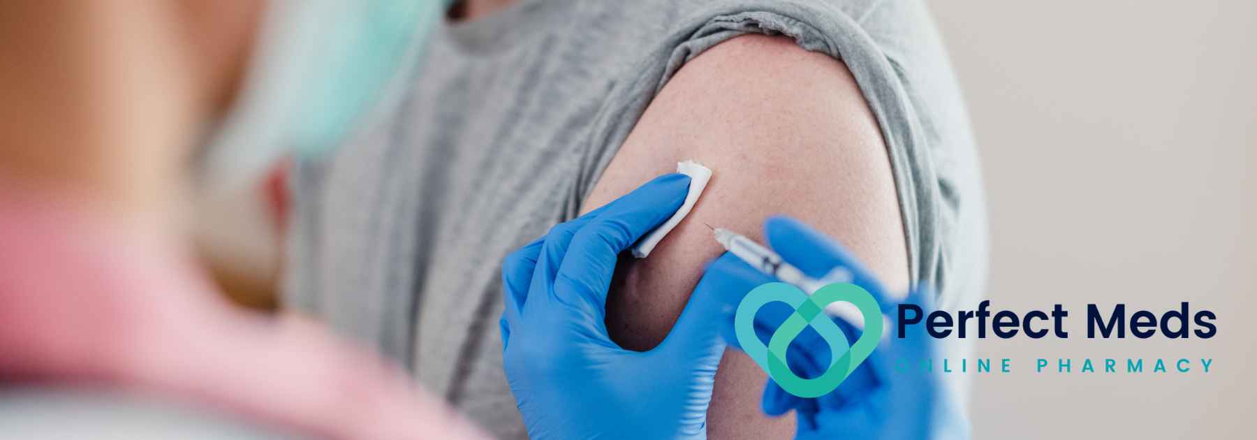 patient in grey shirt receiving vaccine