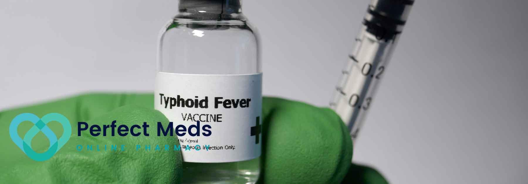 person wearing green medical glove holding typhoid fever vaccine