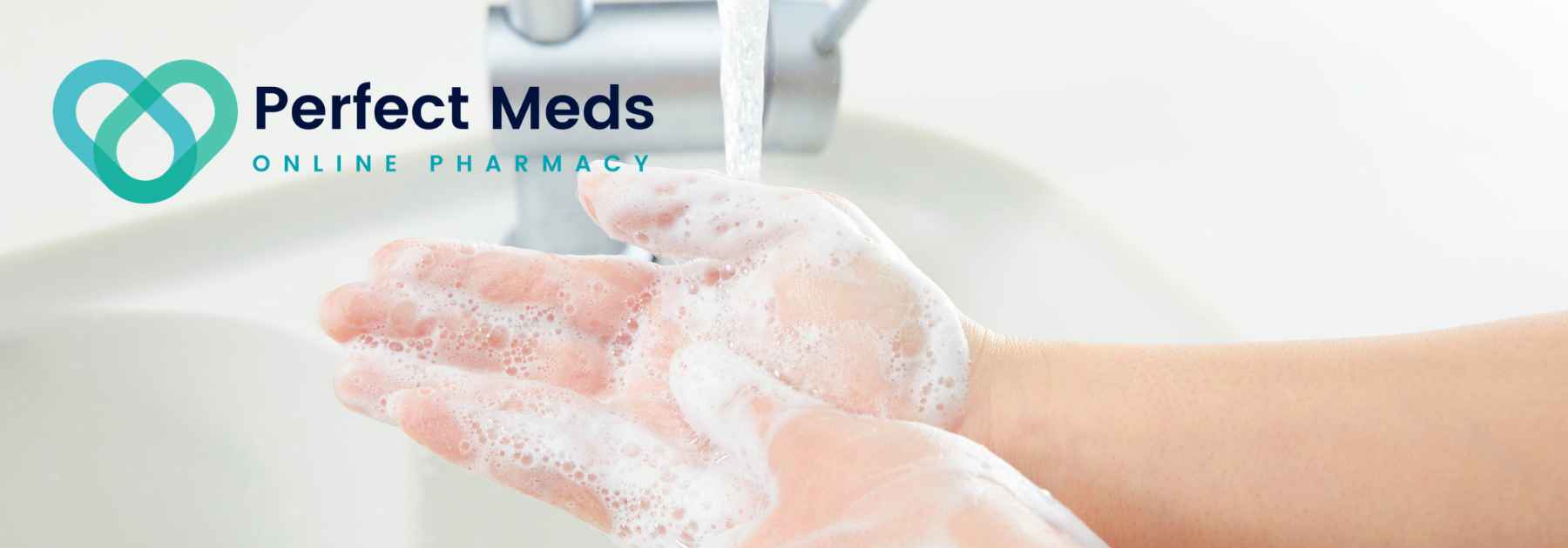 person washing hands with soap and water under tap
