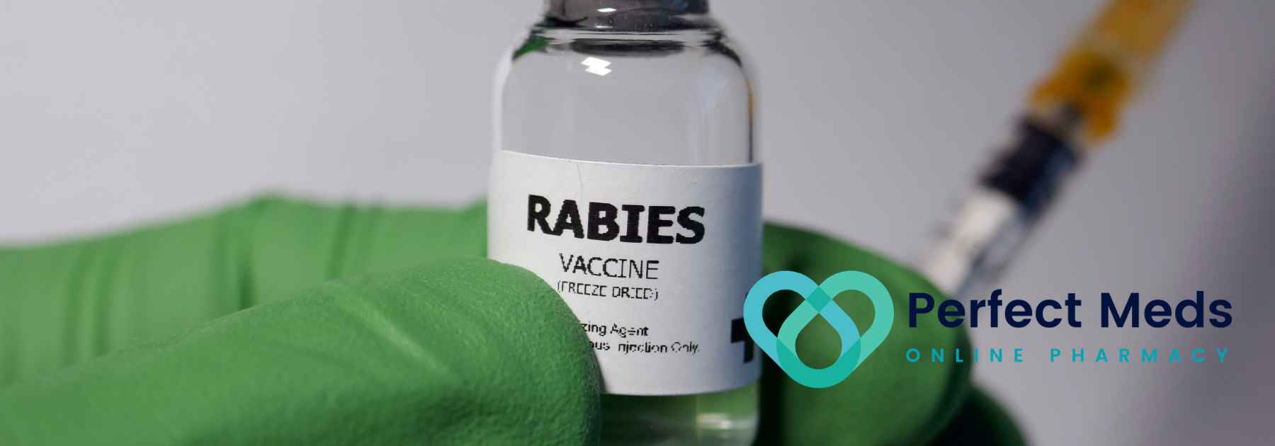 person wearing green medical glove holding rabies vaccine