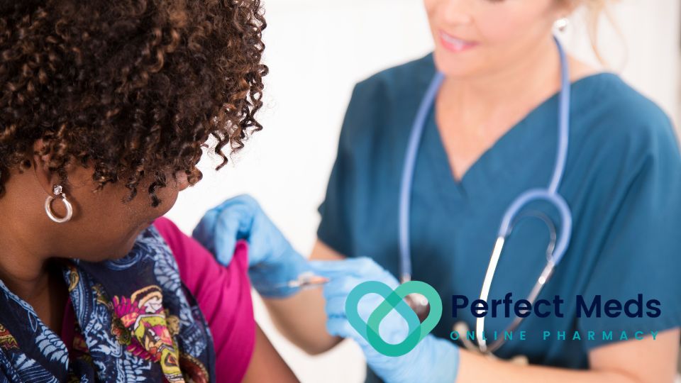female medical professional administering vaccine to female patient